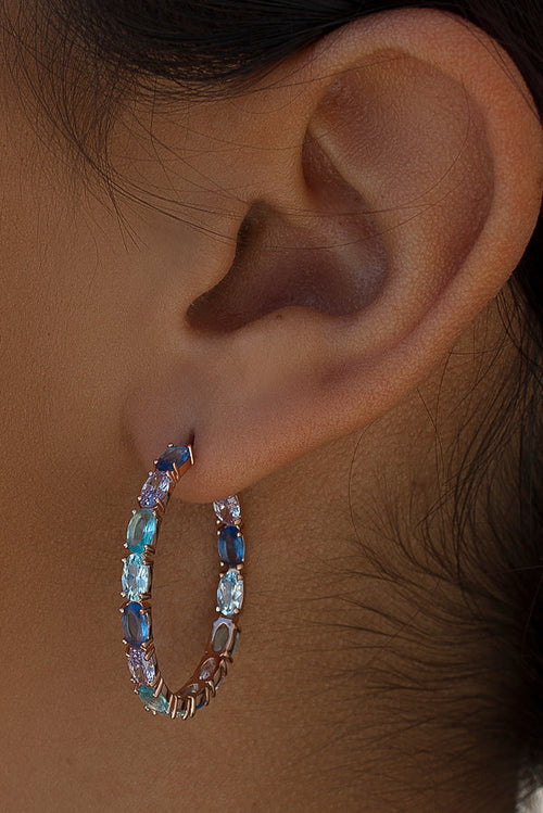 Earrings with colored stones in shades of blue and pink