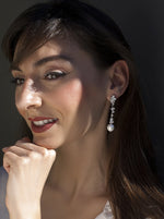 Long bridal earrings with zircons and finished with a pearl in floral motifs