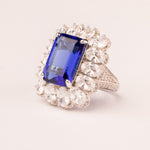 Emerald cut sapphire stone ring with pavé