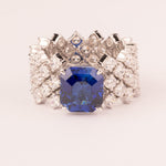 High and soft mesh with central emerald-cut sapphire zirconia