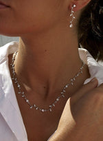 Party necklaces with a curvilinear floral design and zirconia 