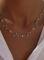 Party necklaces with a curvilinear floral design and zirconia 